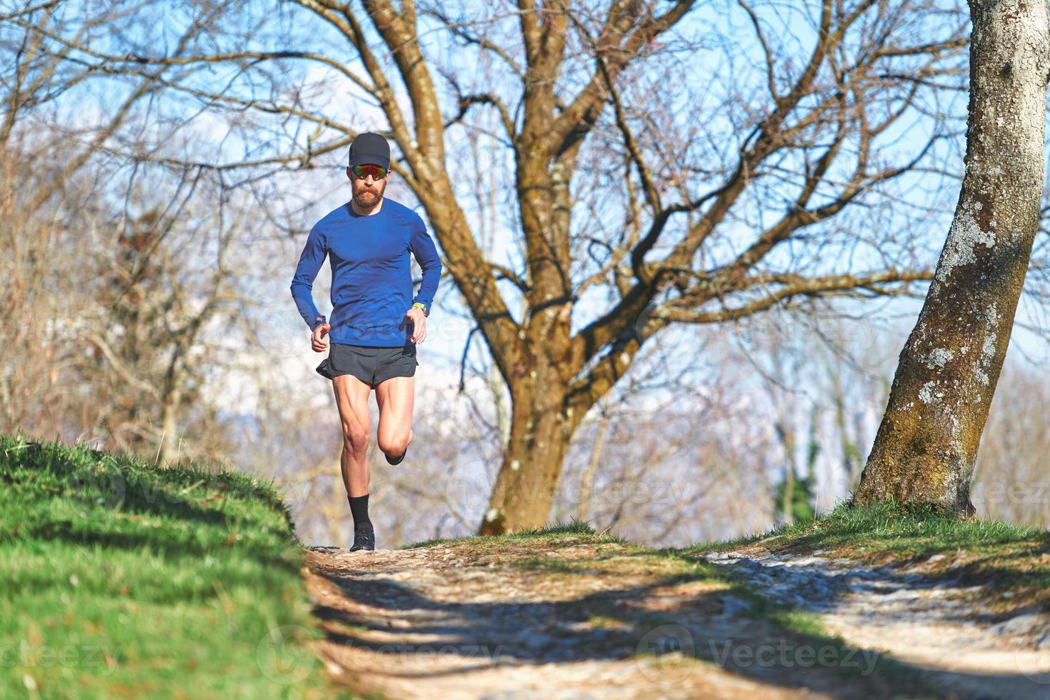 Ultra marathon man athlete during a hill workout photo