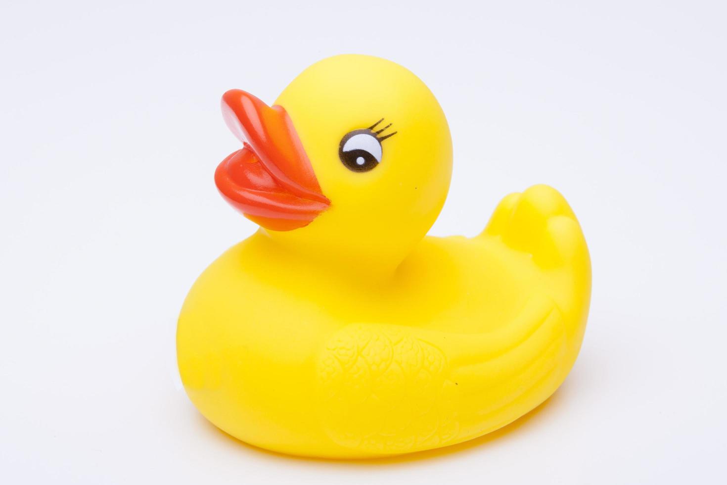 Yellow rubber duck for a kid's bath time, isolated on white background photo