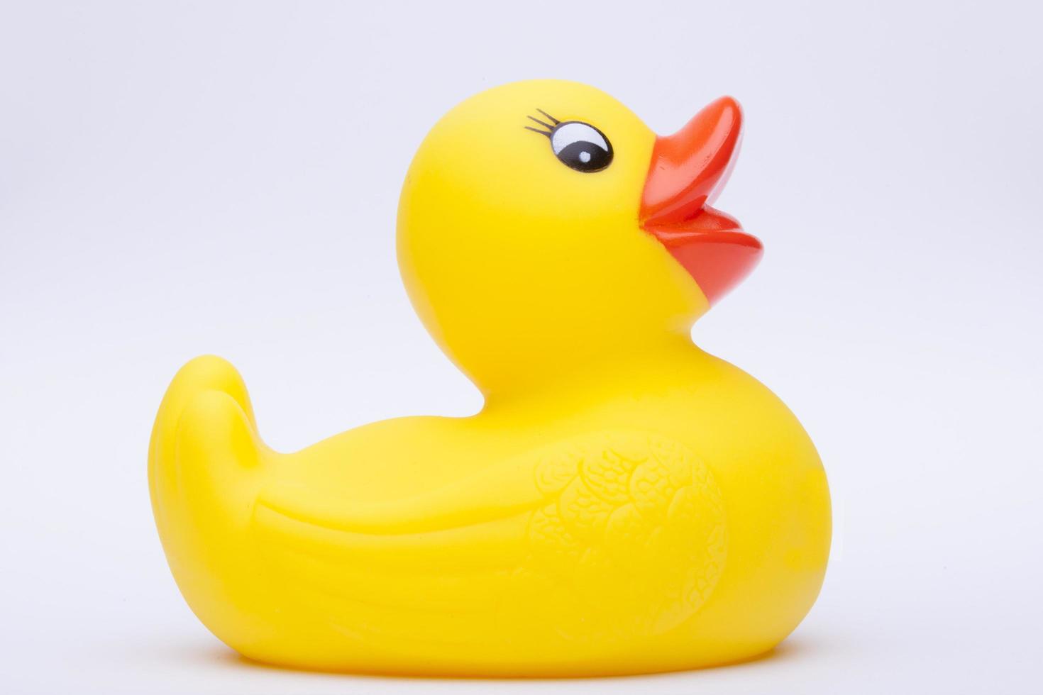 Yellow rubber duck for a kid's bath time, isolated on white background photo