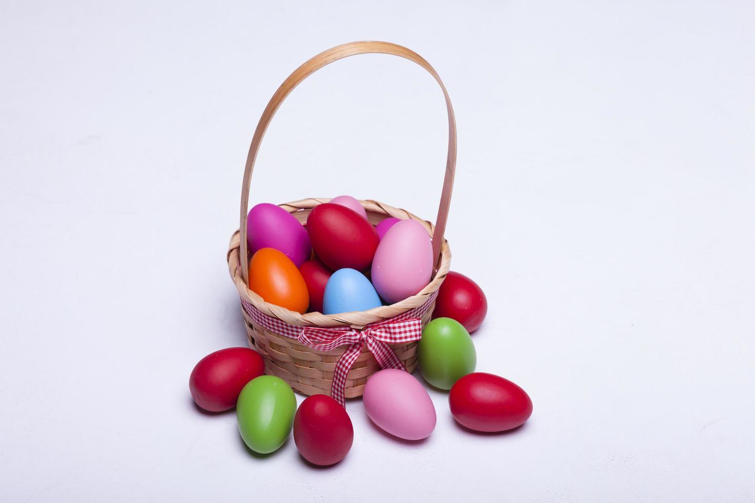 Basket with easter eggs isolated on white background photo