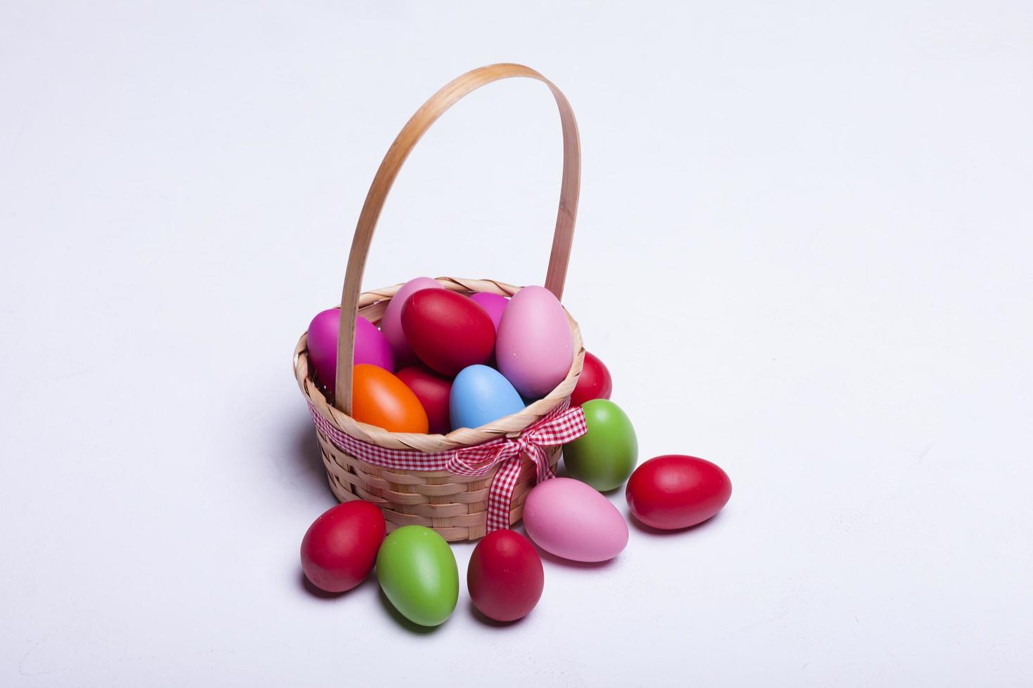 Basket with easter eggs isolated on white background photo