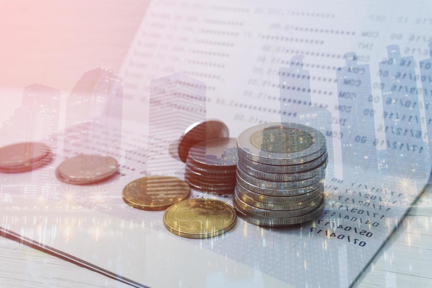 Double exposure of a cityscape background with coins on a statement book bank for accounting, finance banking concept photo