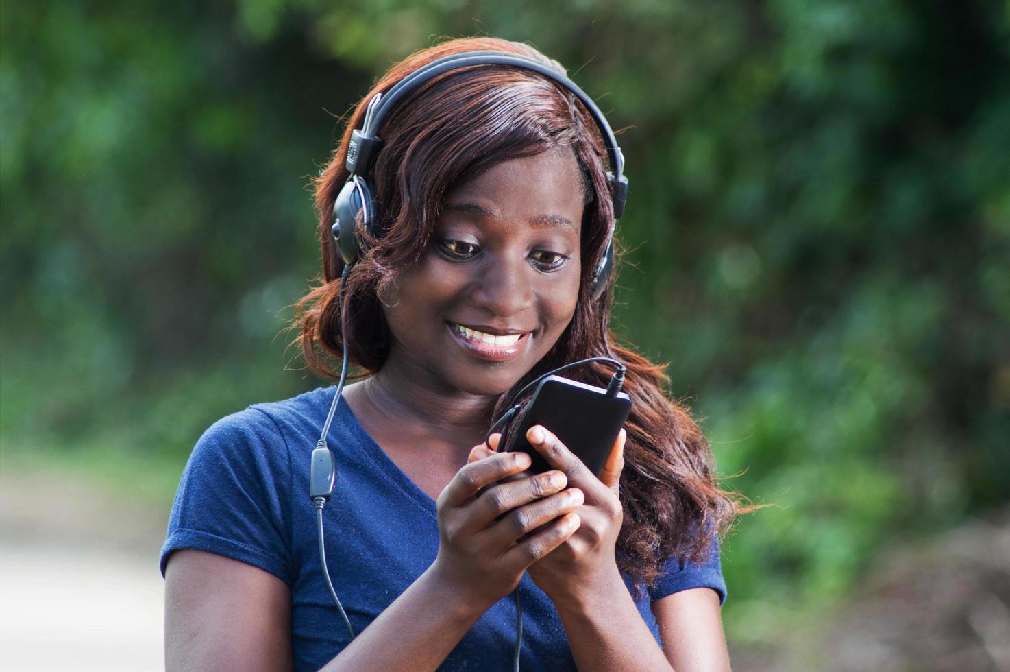 Pretty woman happy with her discovery on her mobile phone photo