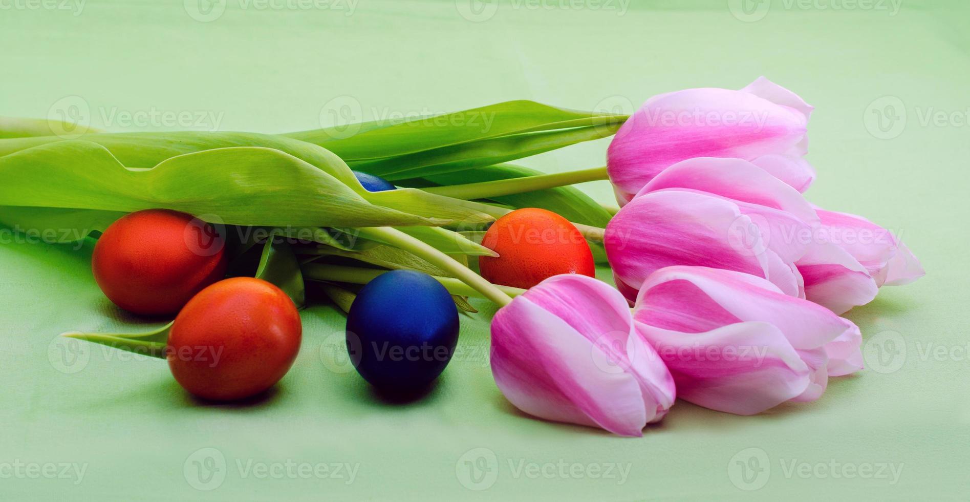 Tulips with colored eggs photo