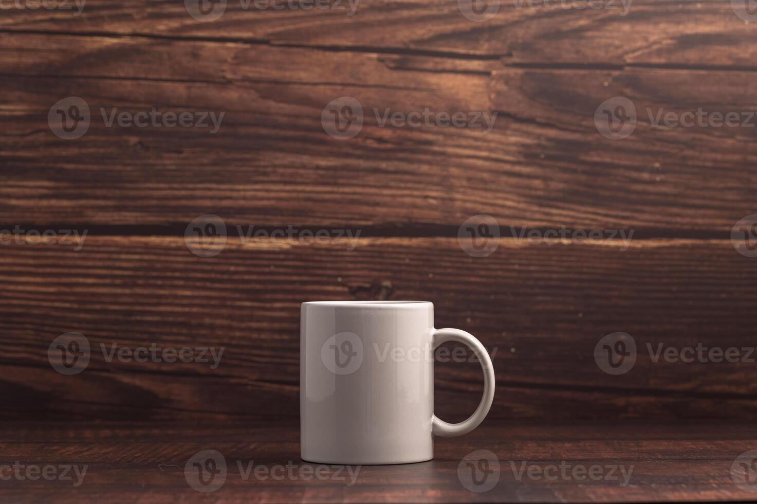 A white coffee mug on a wooden table photo