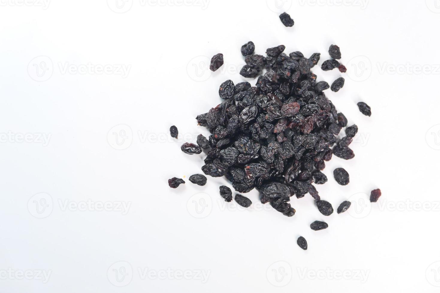 Black raisins on white background photo