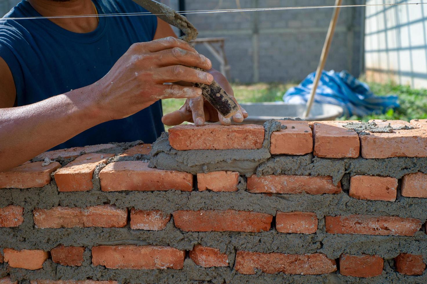 Hands of worker holds the trowel and installs bricklayers photo