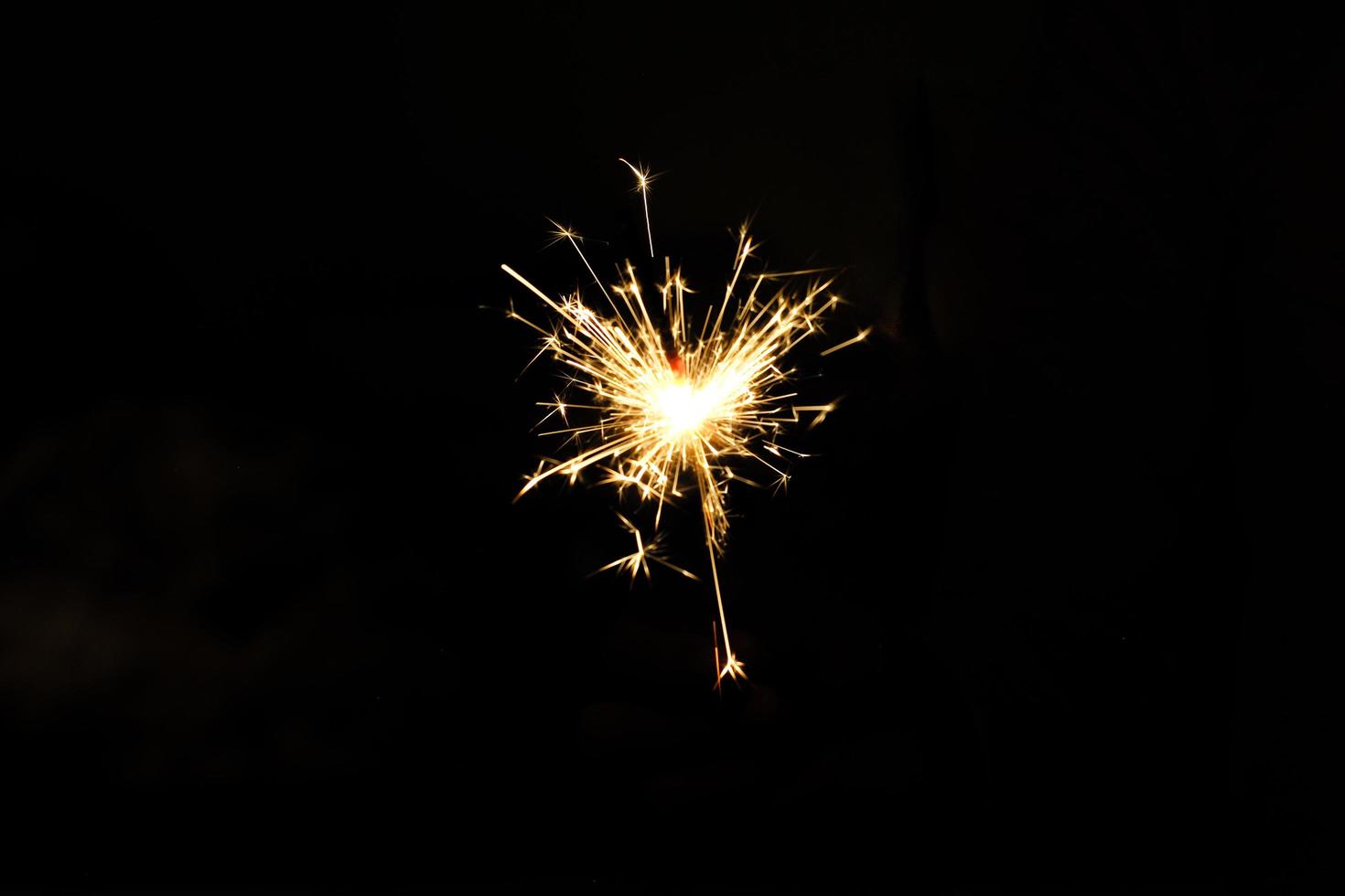 Abstract isolated sparkling fireworks in a heart shape on dark night background photo