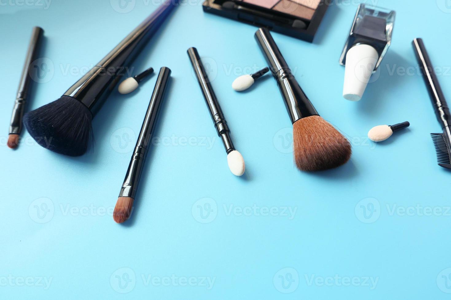 Top view of cosmetic tools on blue background photo