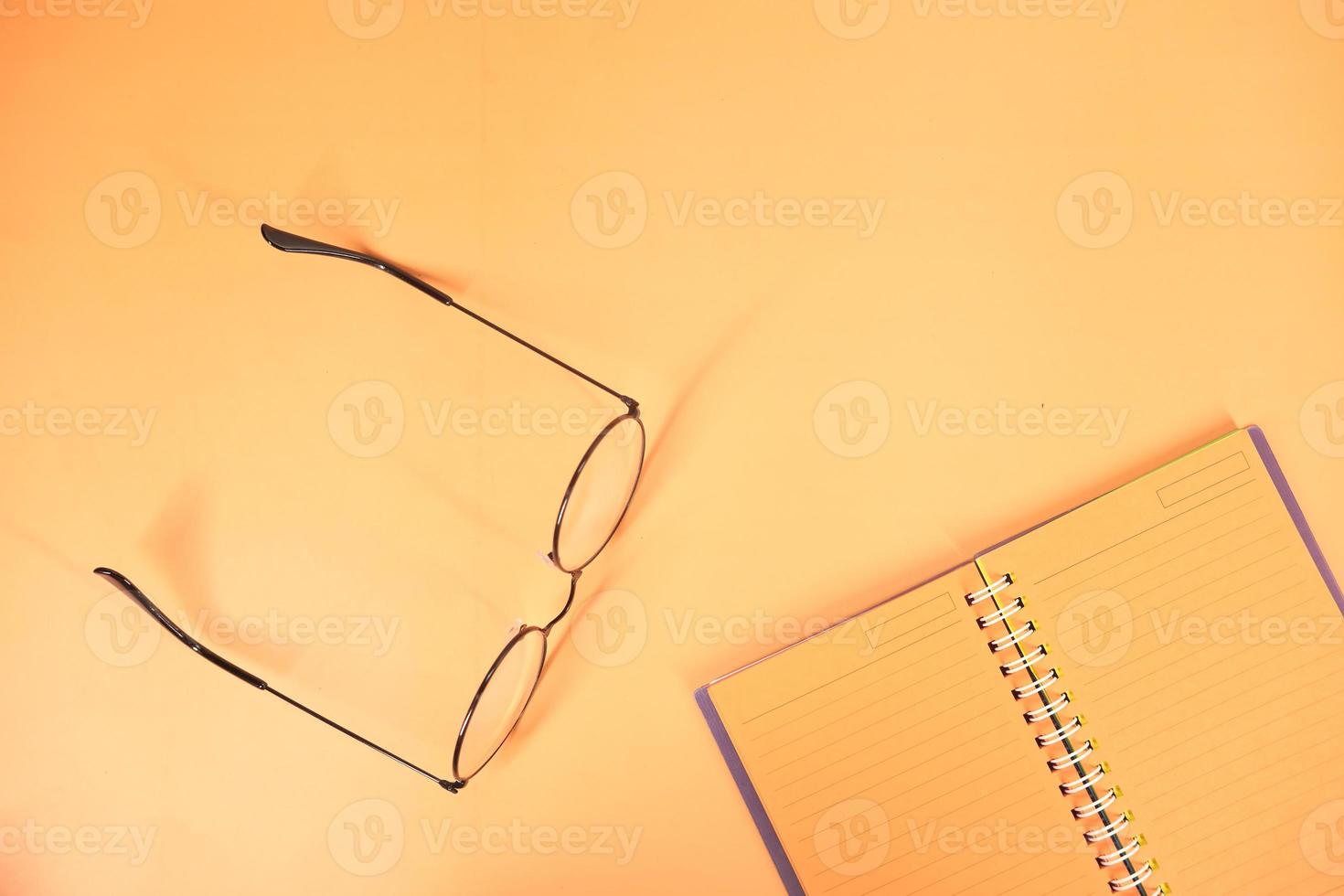 Orange notepad on orange background photo