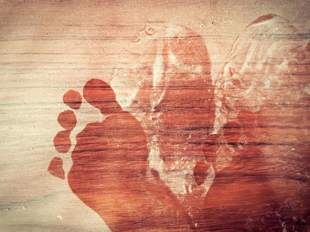 Abstract footprint on the dusty wooden floor photo