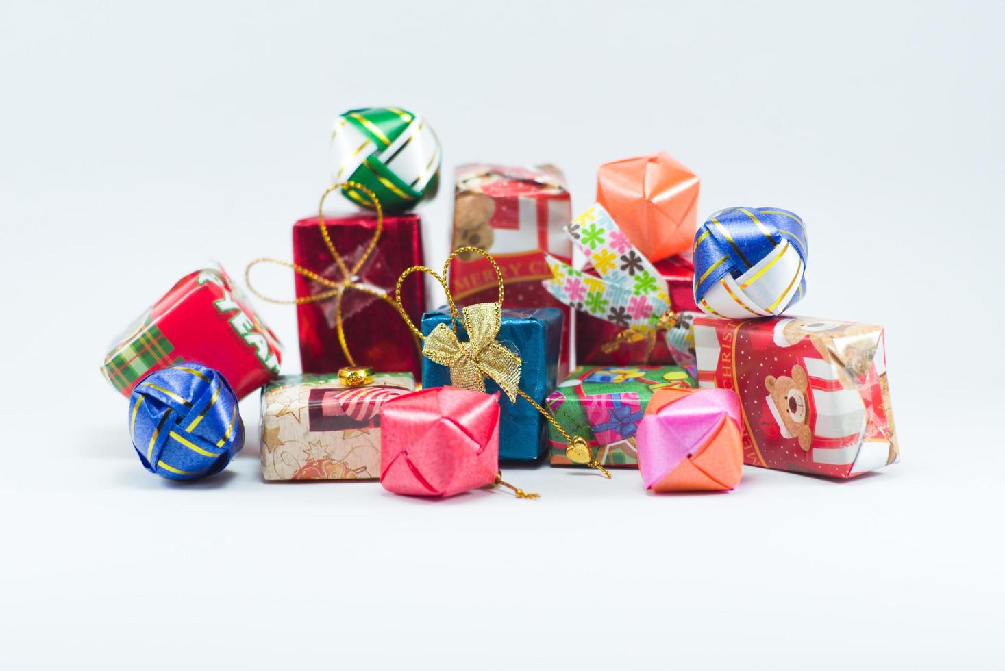 Closeup pile of gift boxes wrapped by colorful paper photo