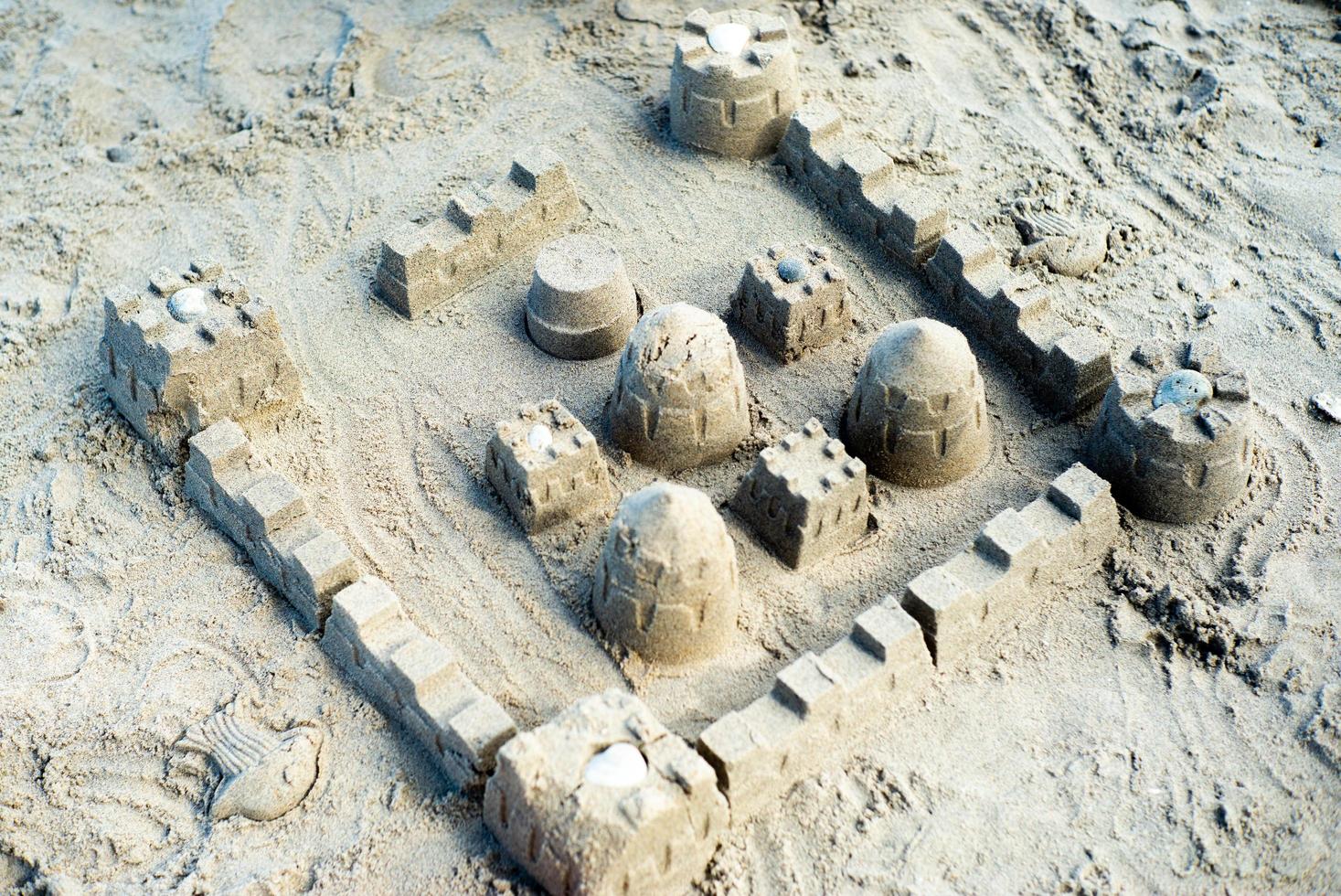 The sandcastle built by using the mold on the beach photo