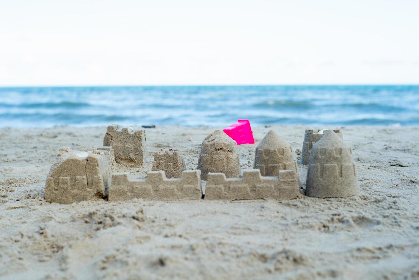 The sandcastle built by using the plastic molds on the beach photo