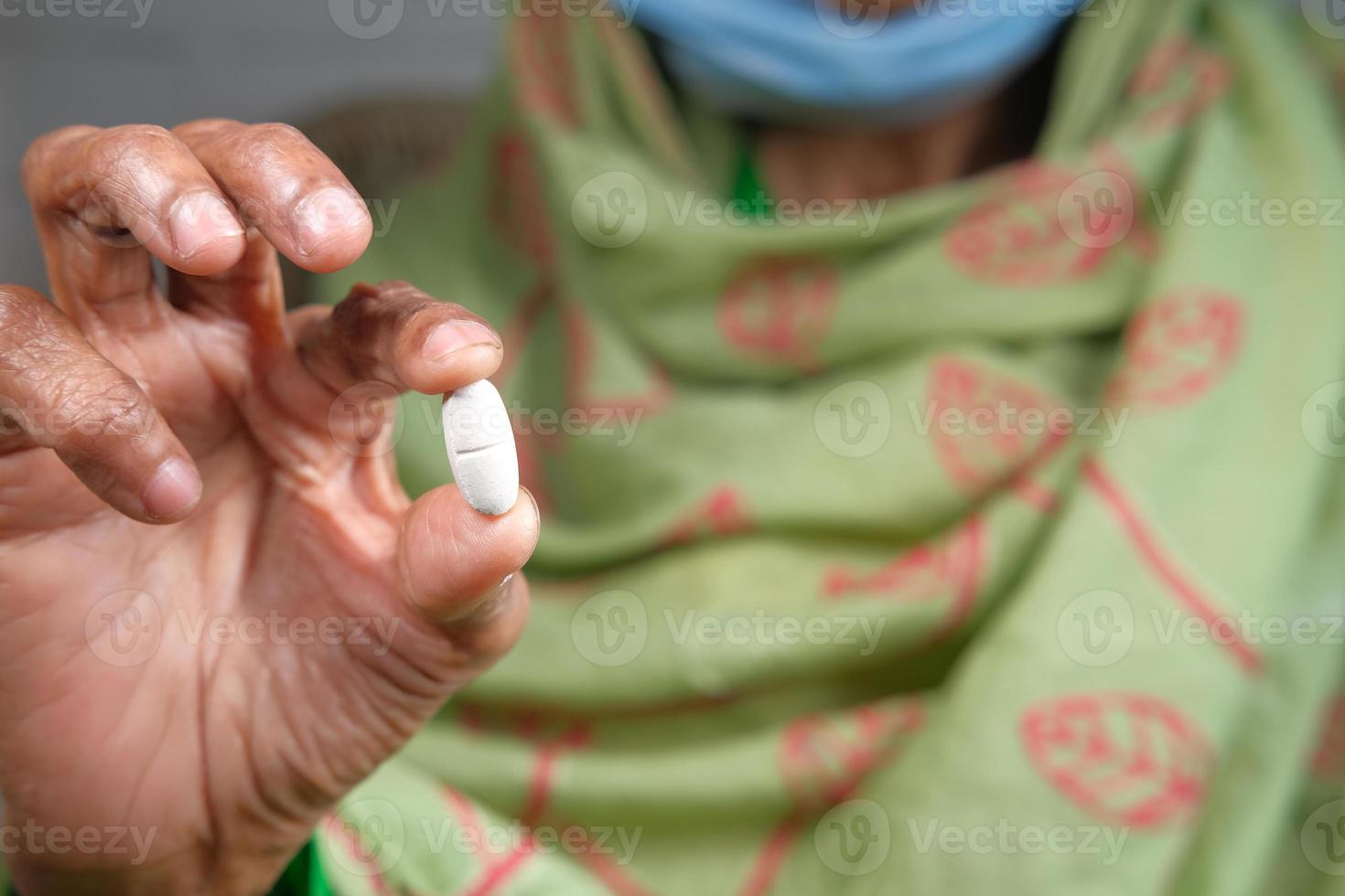 Hand holding pill with copy space photo