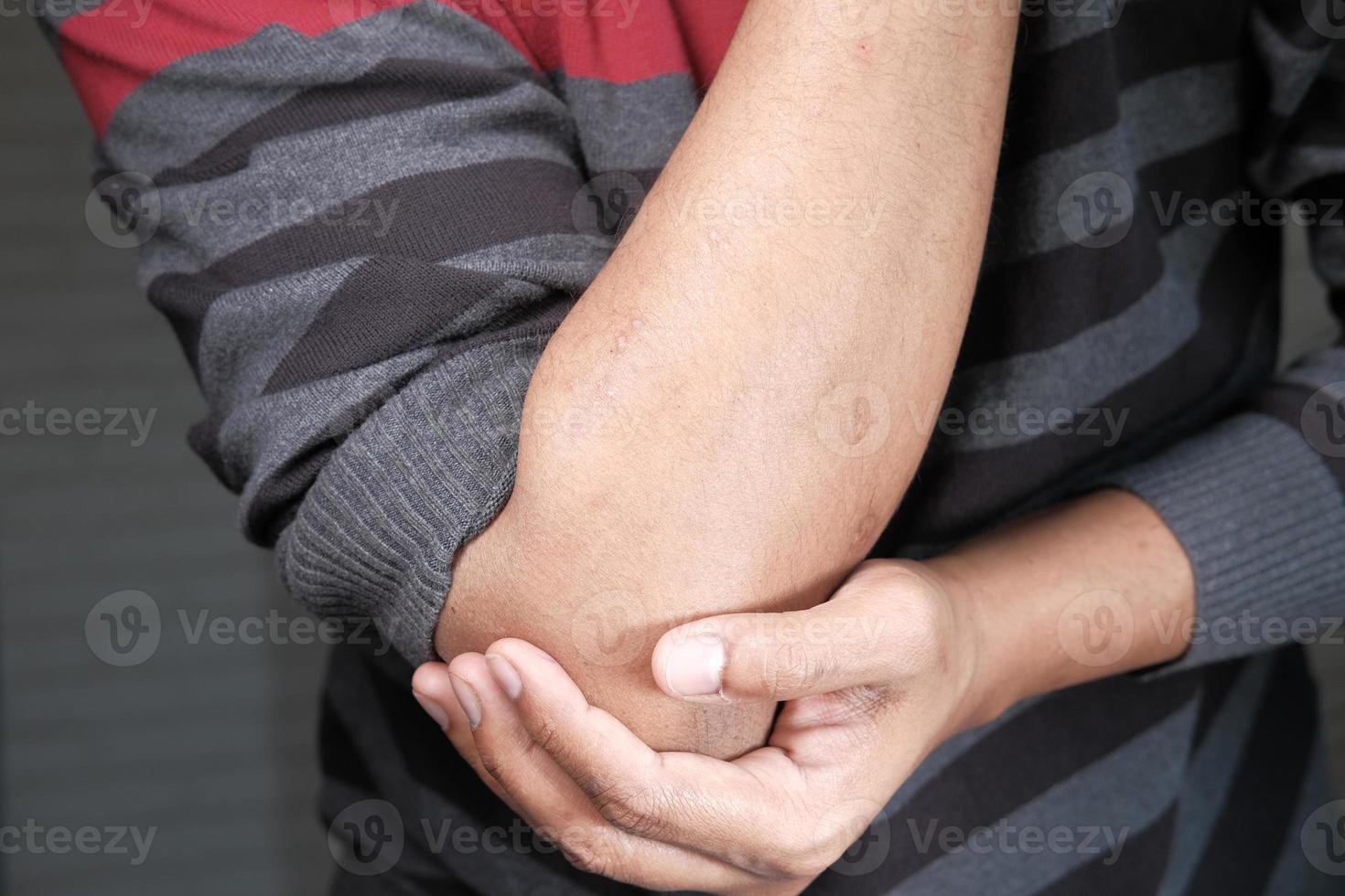 Man holding elbow photo