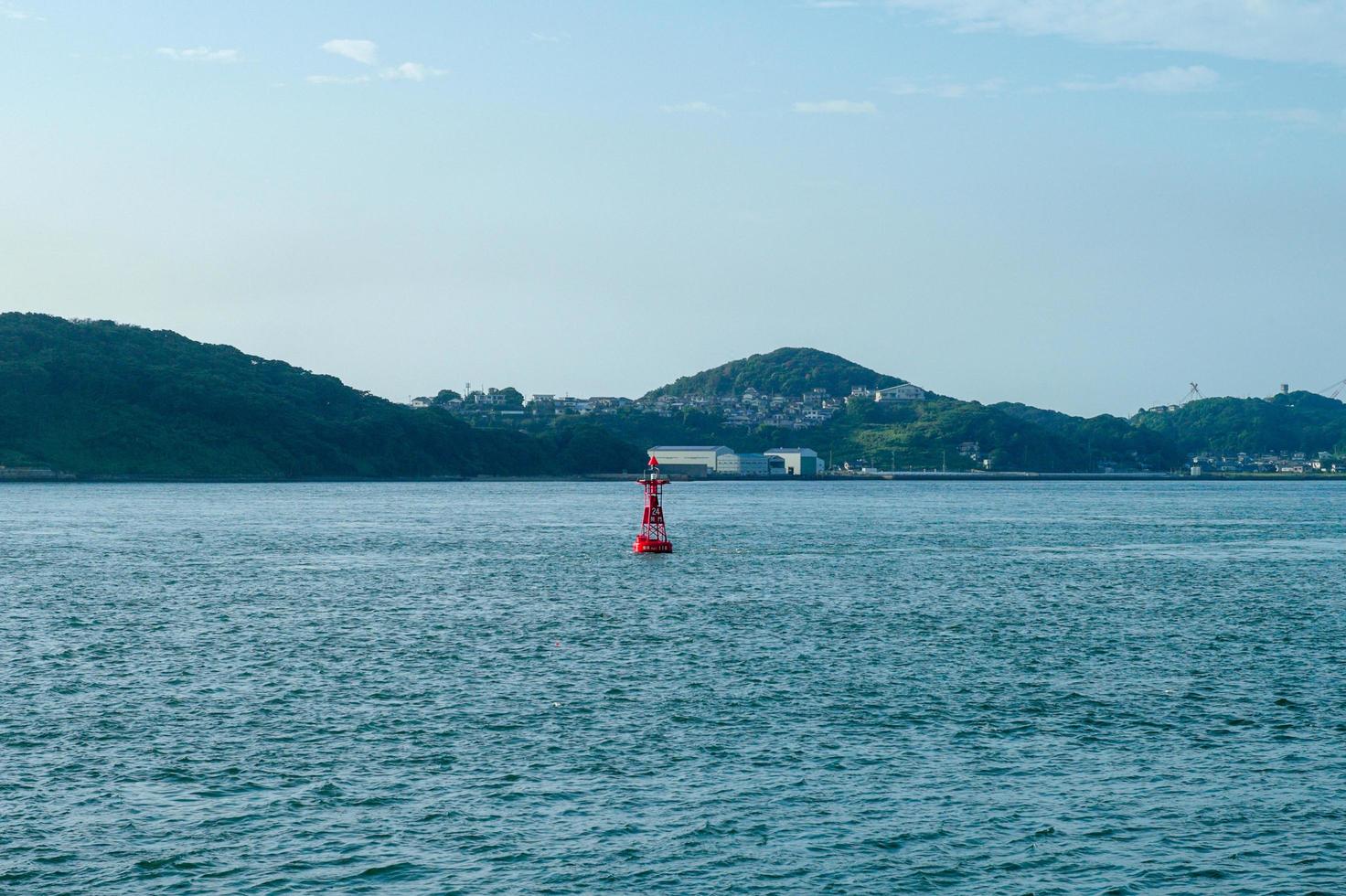 Red buoy floating in the sea photo