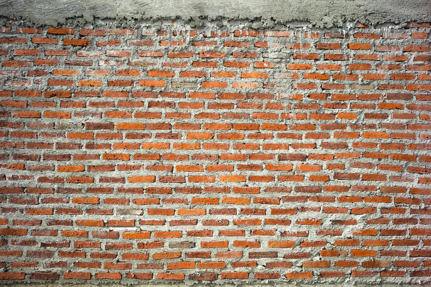 Abstract texture and background of red brick and bricklayer concrete wall photo