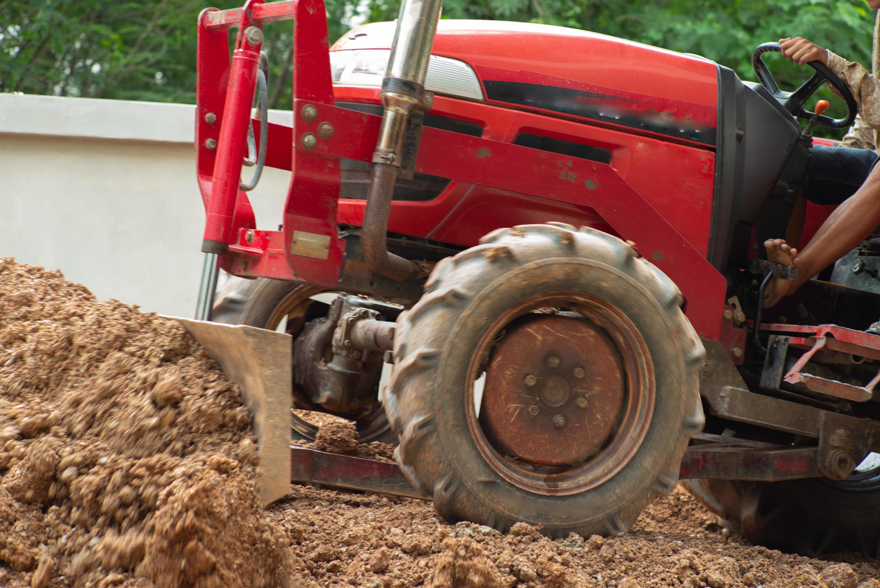 Worker driving the tractor for grading the level of ground 2229902