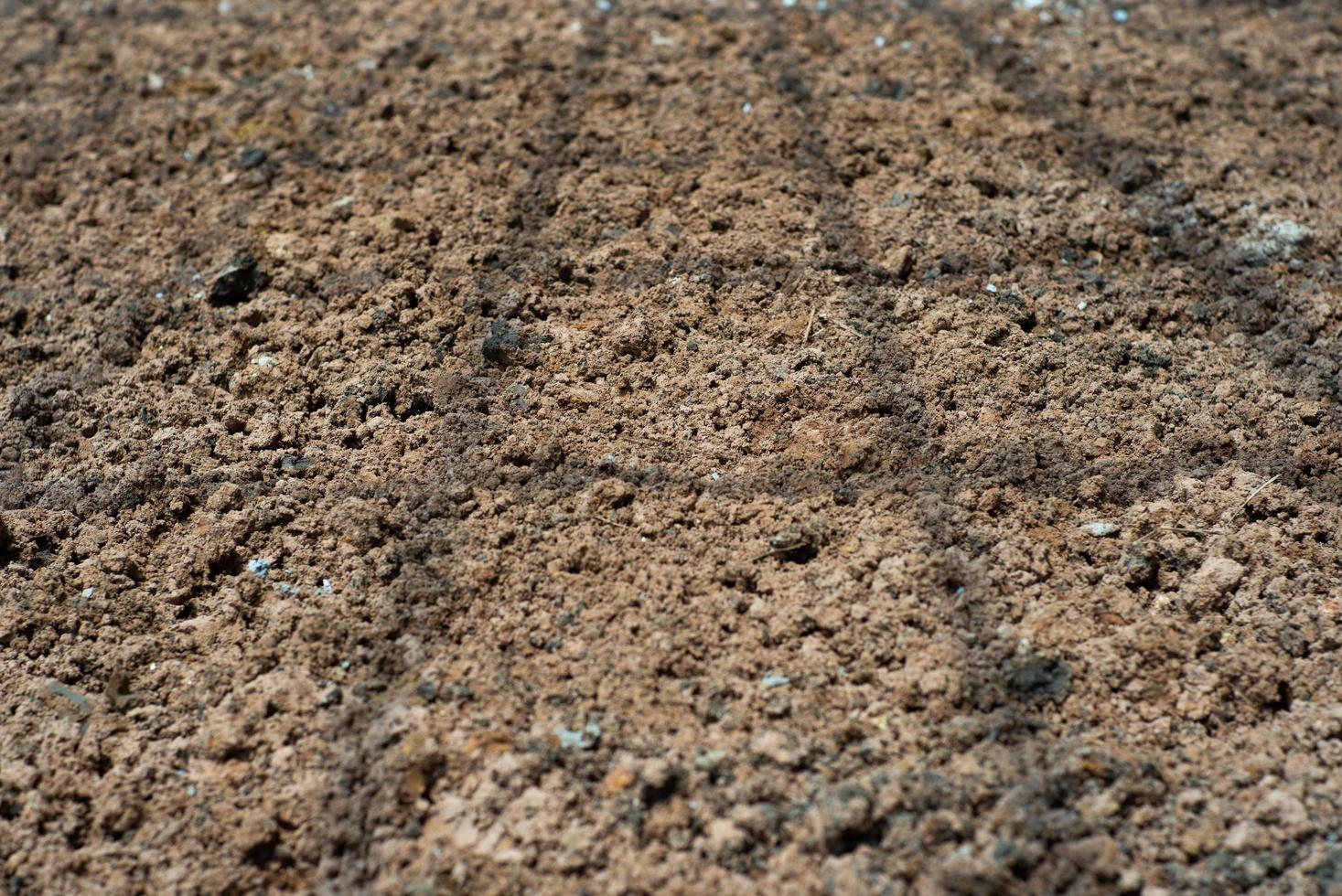 Abstract background and texture of soil with the shadow of steel structure on the ground at construction site photo