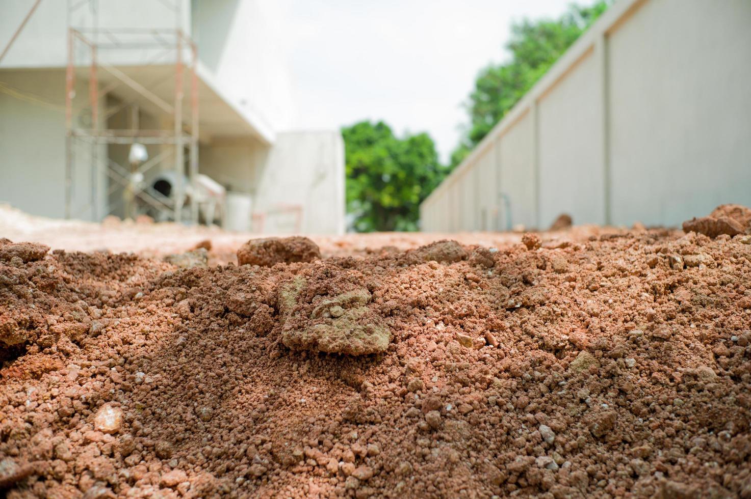 Closeup texture of soil on the floor with blurred construction site in background photo