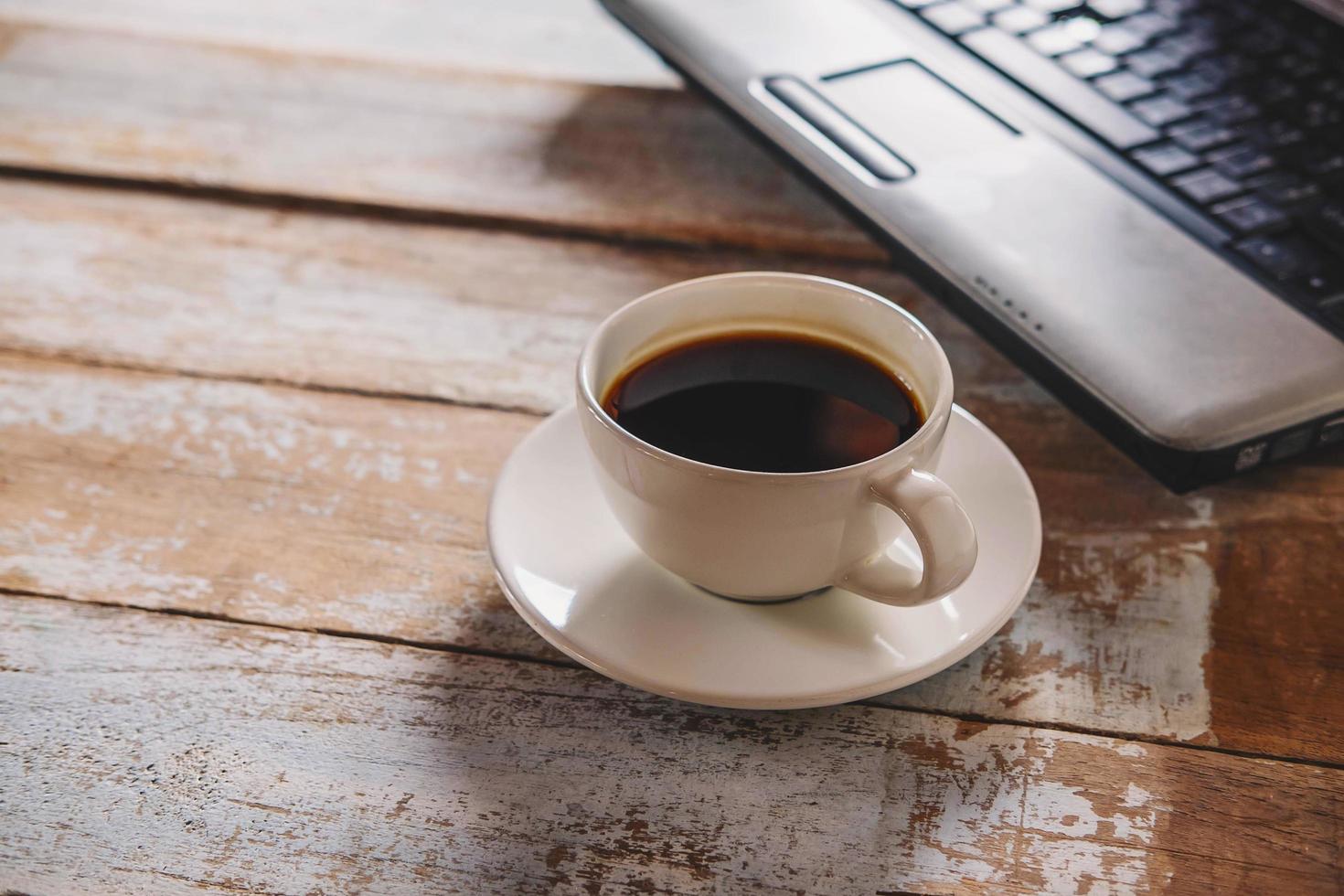 Coffee and saucer with a laptop photo