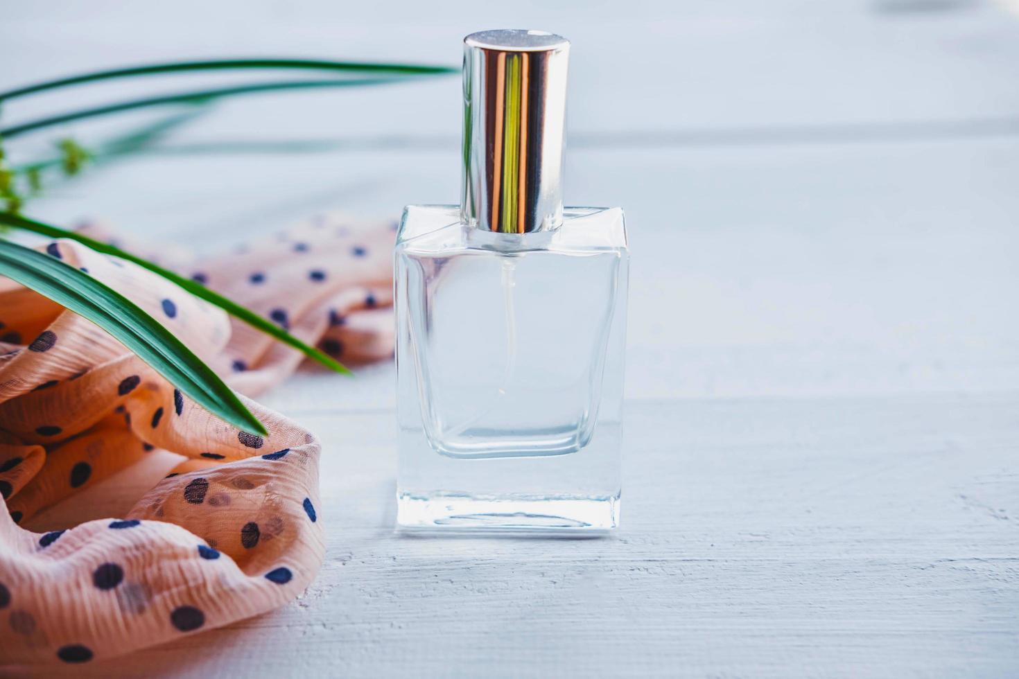 Perfume with a plant and ribbon photo