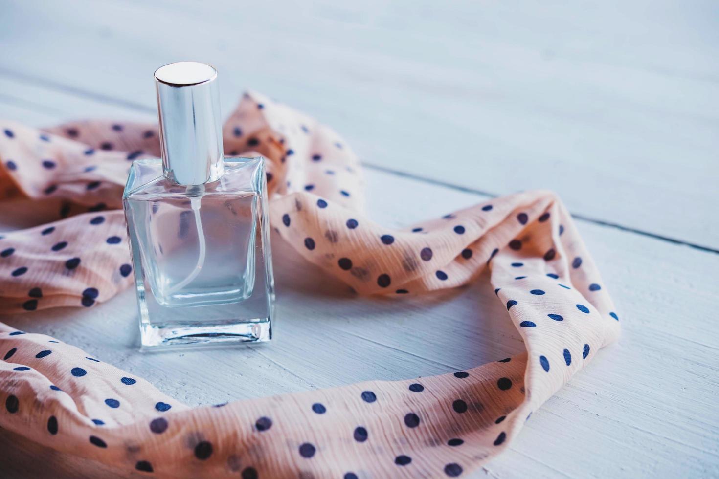 Perfume and pink polka-dot ribbon photo