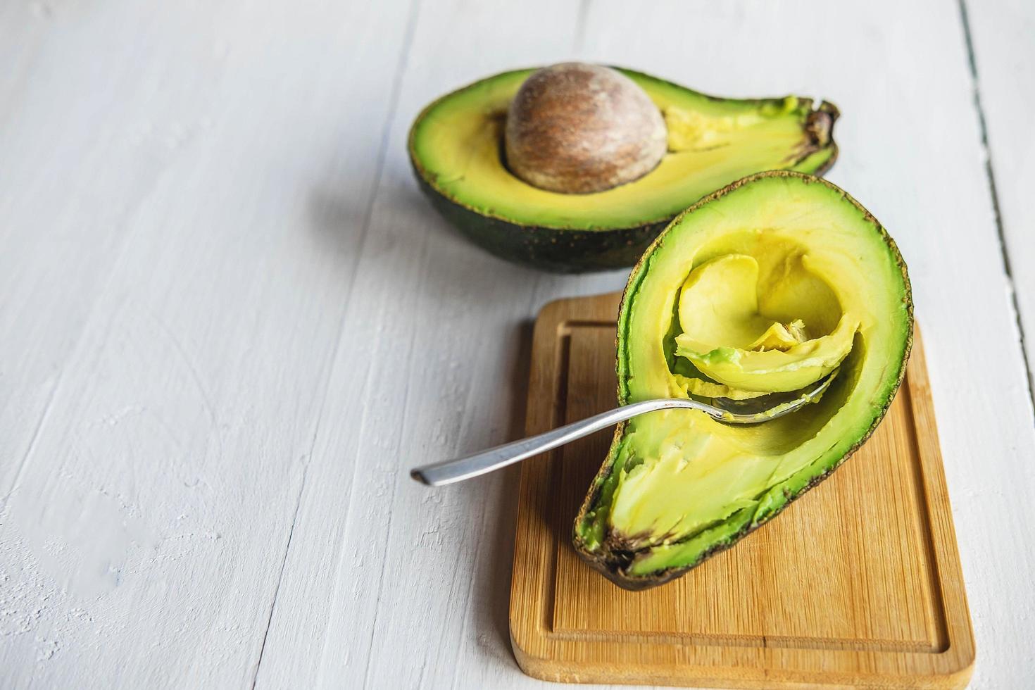 Halved avocado on wood photo