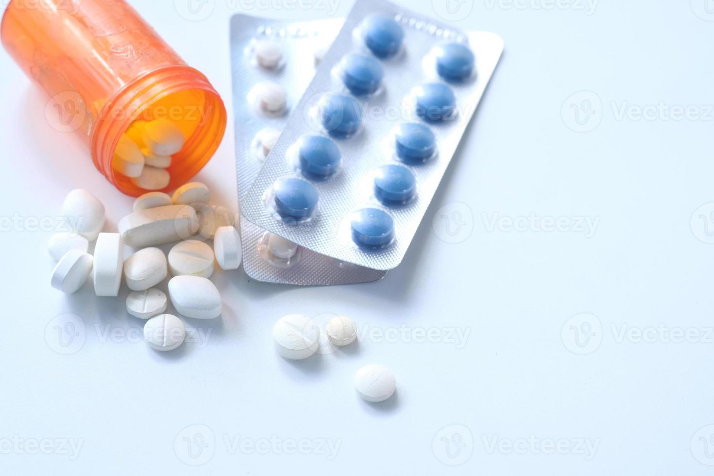 Pills spilling on white background photo