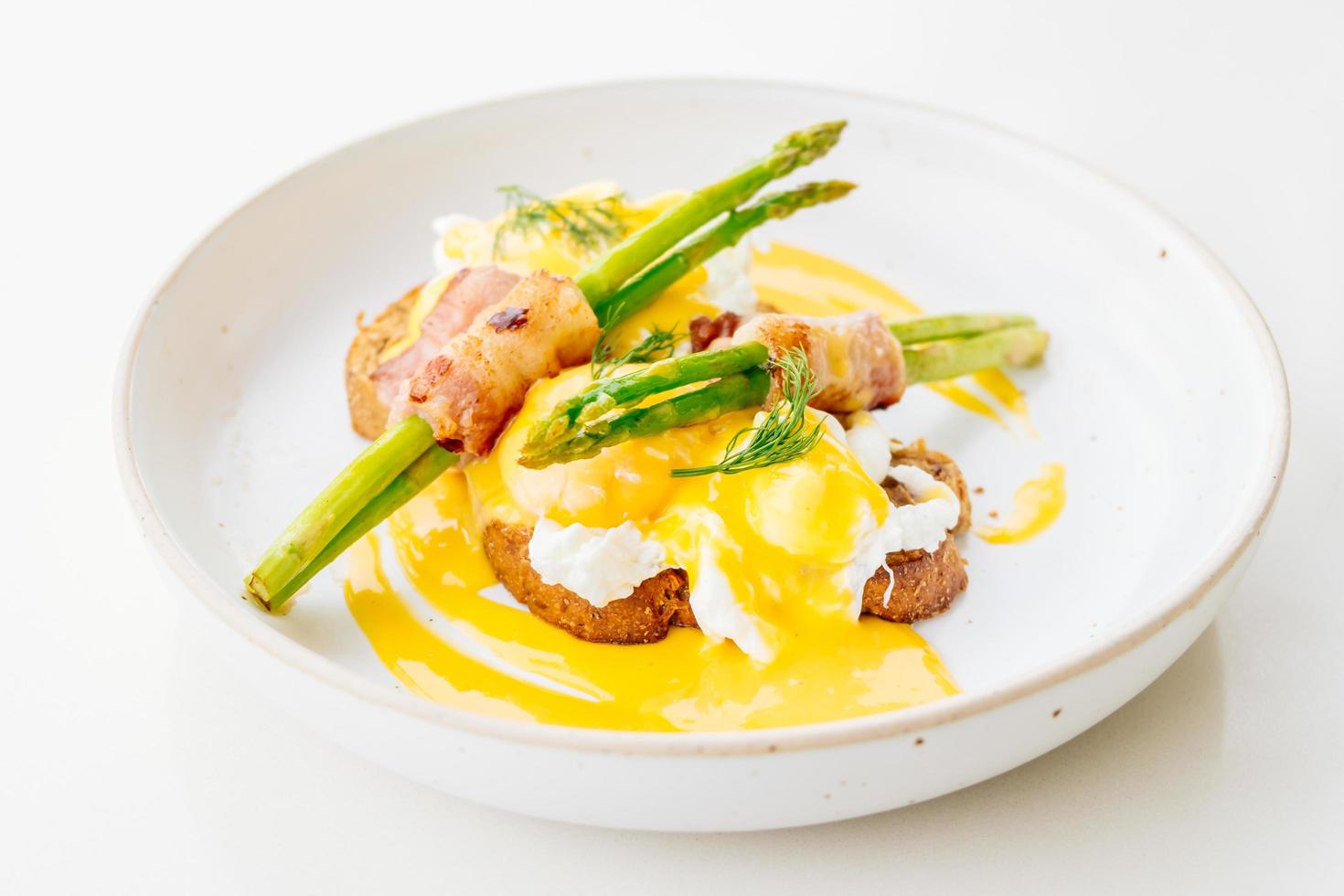 Eggs benedict with bacon twist asparagus photo