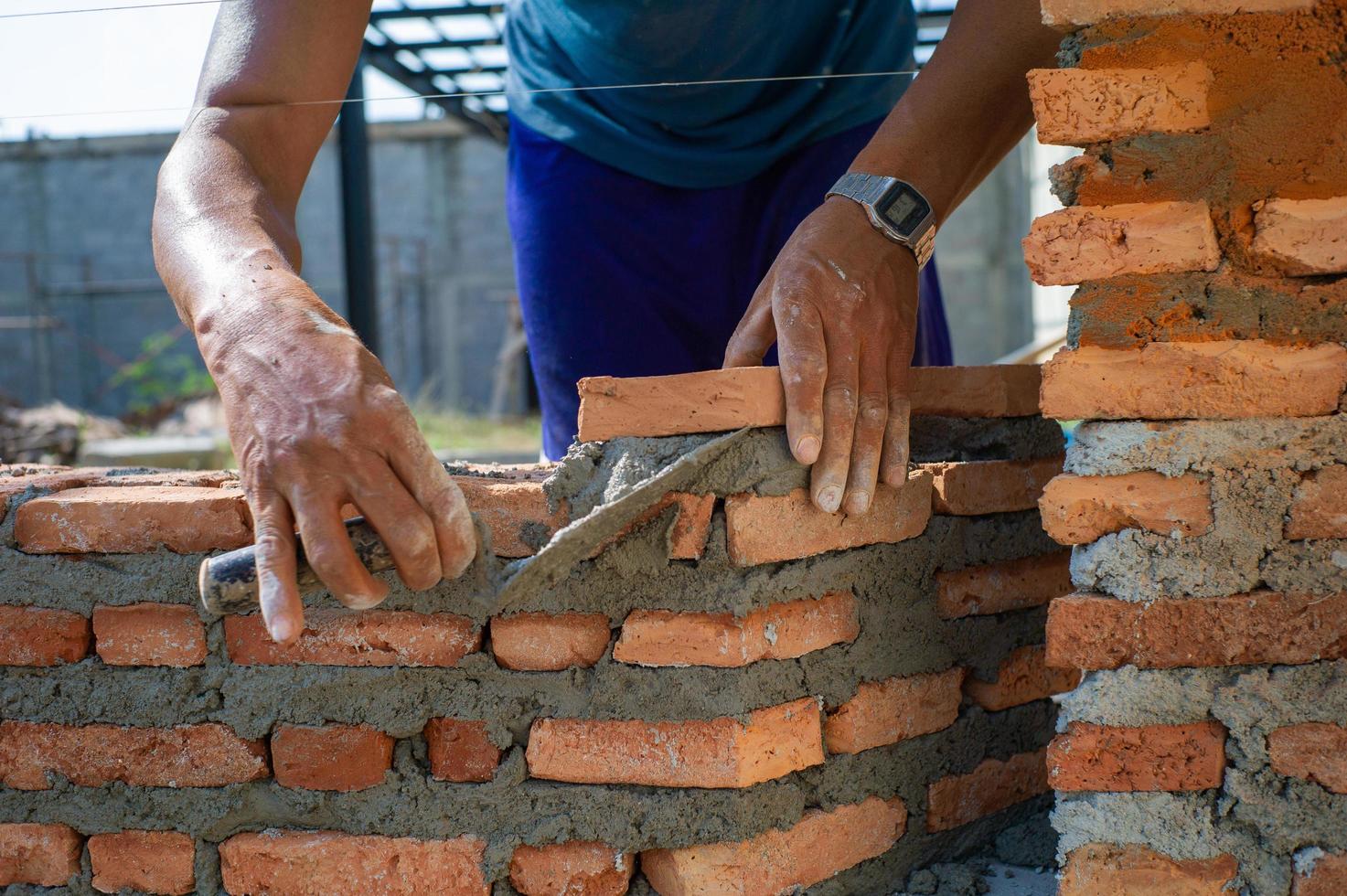 Closeup textura y fondo de albañiles naranja instalado por trabajador en el sitio de construcción foto