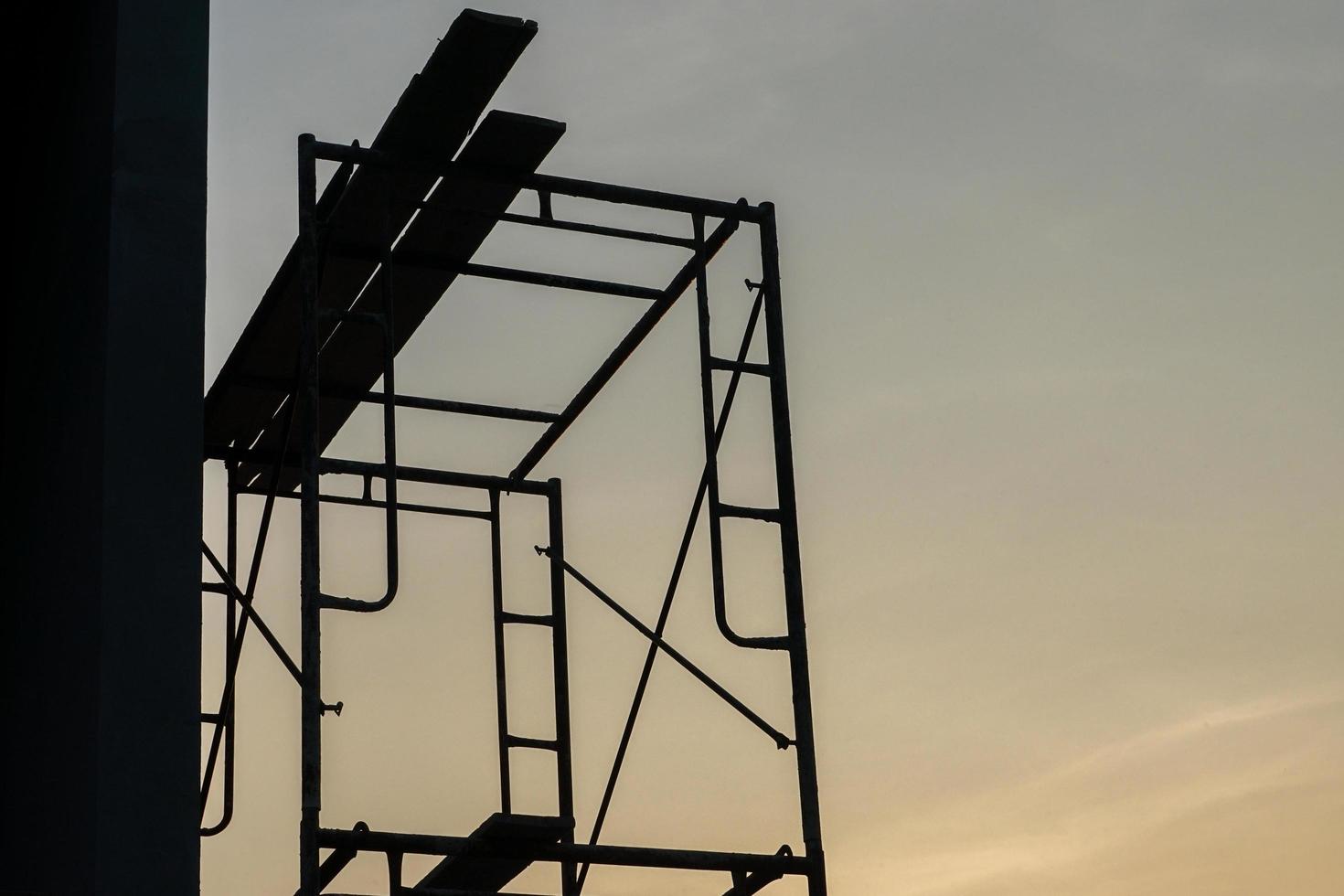 Silhouette steel scaffolding with twilight sky background at the constrcution site photo