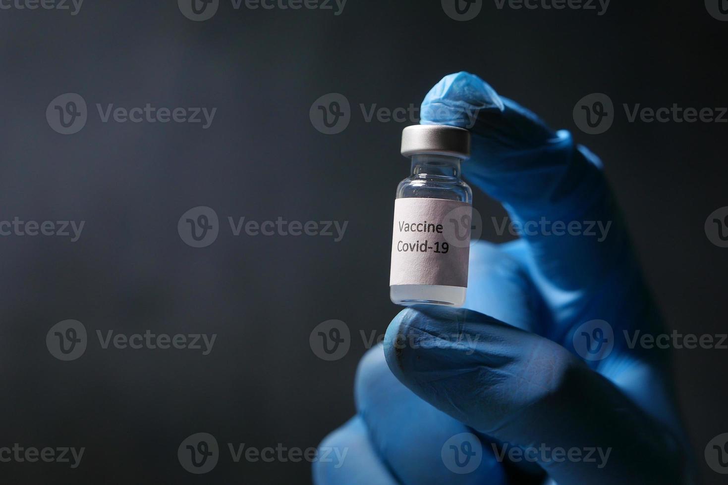 Coronavirus vaccine isolated on black photo