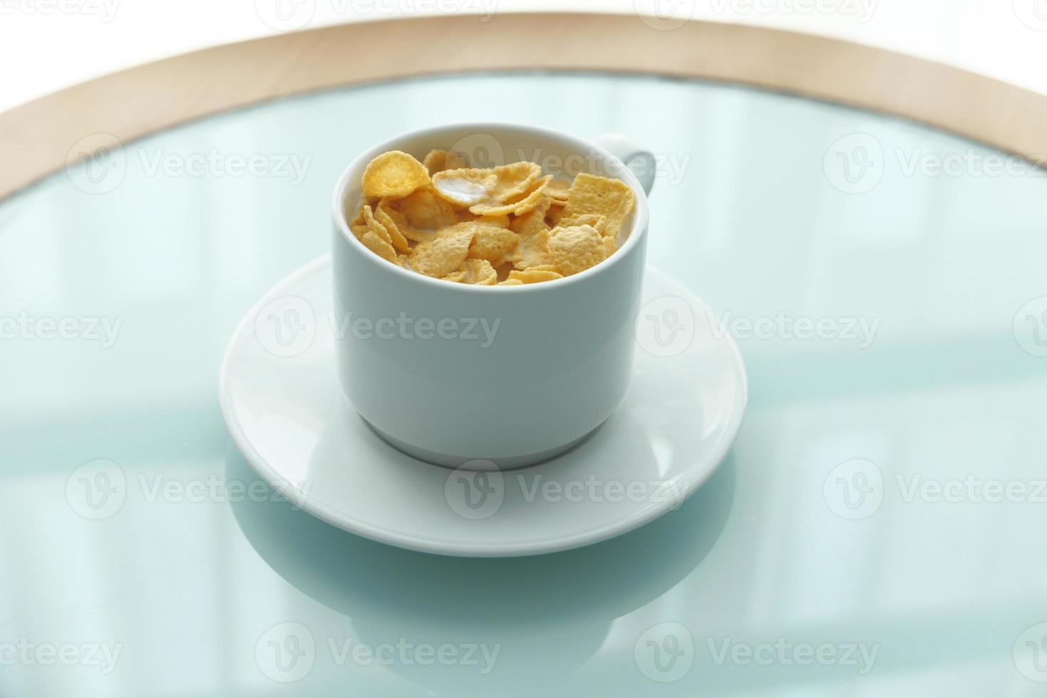 Corn flakes in a bowl on table photo