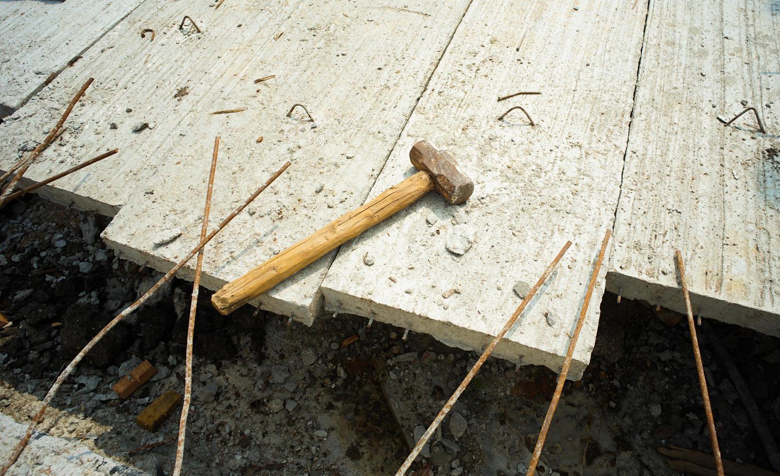 Hammer puts on the reinforcement steel of concrete floor photo