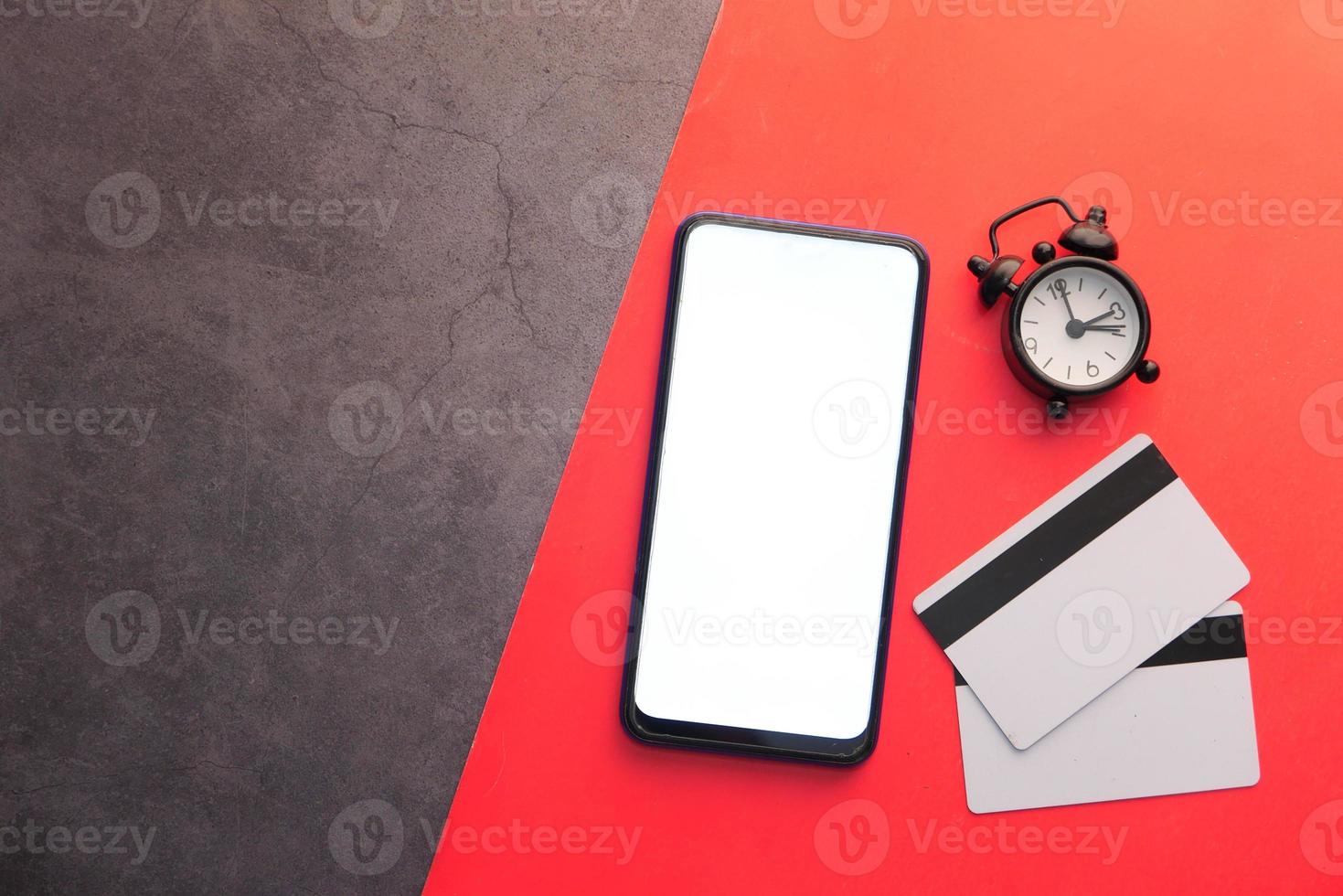 Smart phone with blank screen on red and black background photo