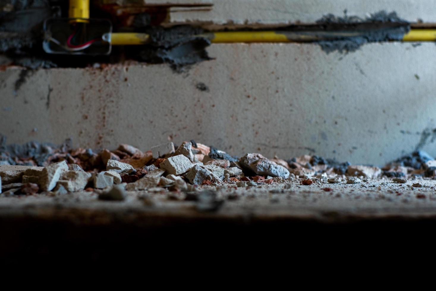 Selective focus picture of crushed concrete lump with blurred broken plastered cement photo