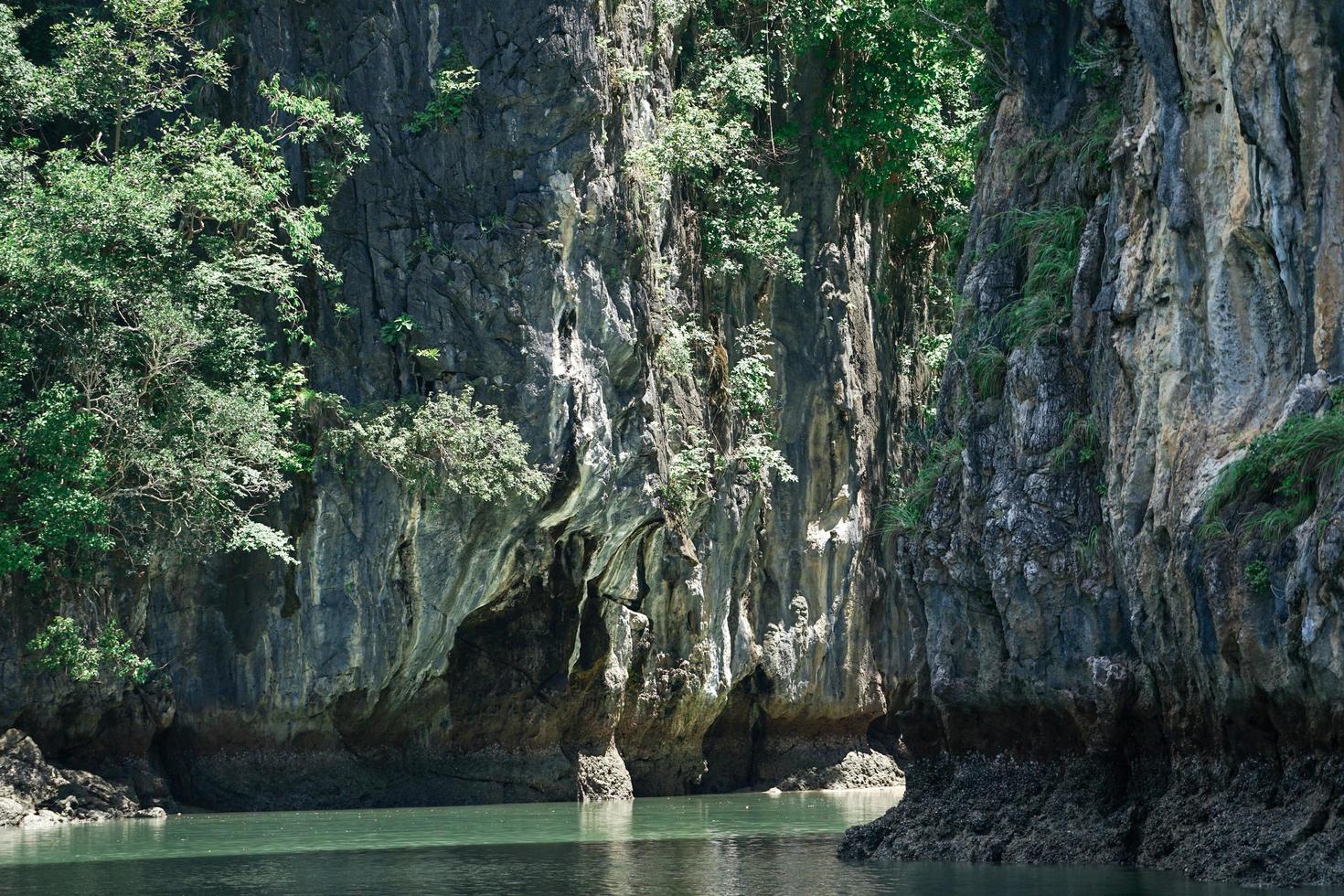 Selective focus on rocky cliff of island in sunny day photo