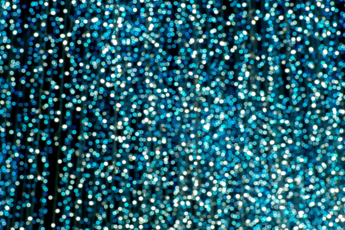 Abstract picture of blurred glittering turquoise bokeh in background photo