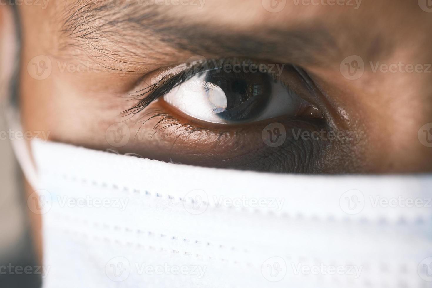 Close up of man's eye with mask photo