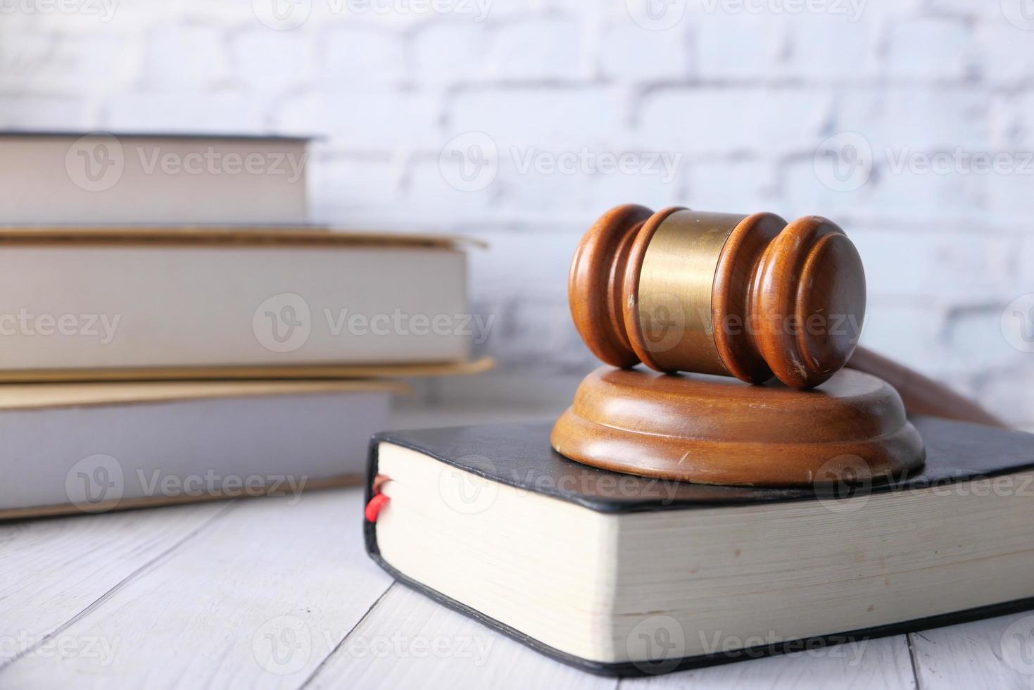 Close up of gavel and books on table photo