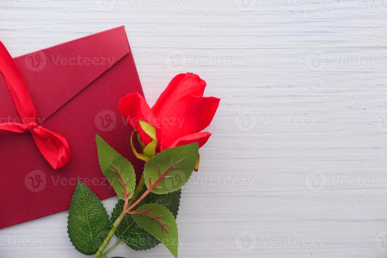 Envelope and rose flower on white background with copy space photo