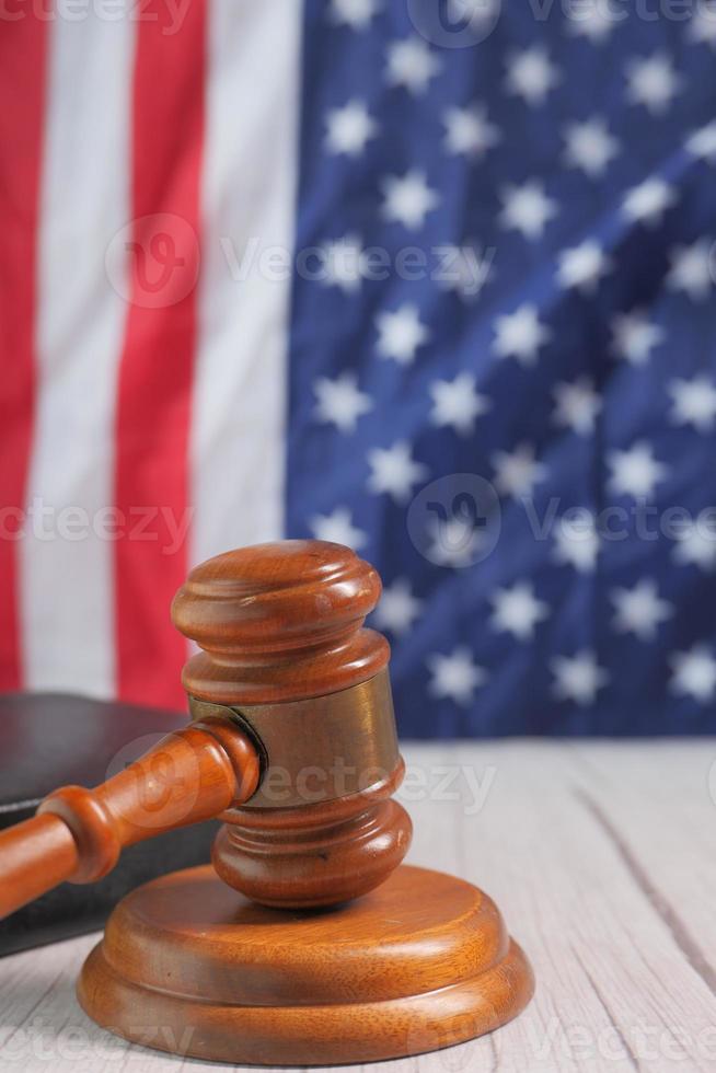 Closeup of gavel and book against American flag photo