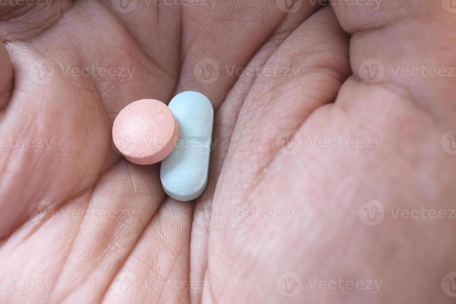 Close up of man's hand taking medicine photo