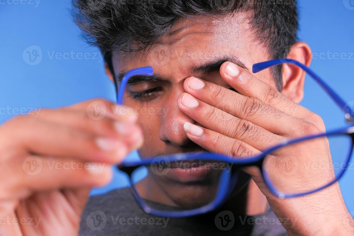 Close up of upset man suffering from strong eye pain photo