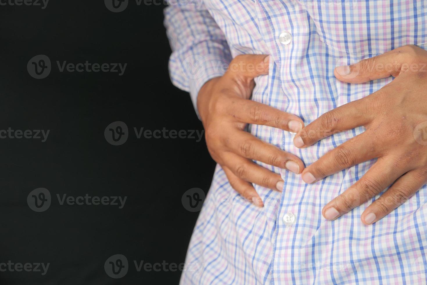 Man suffering stomach pain close up photo