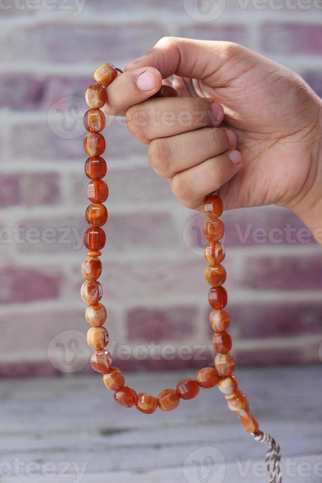 Person holding prayer beads photo