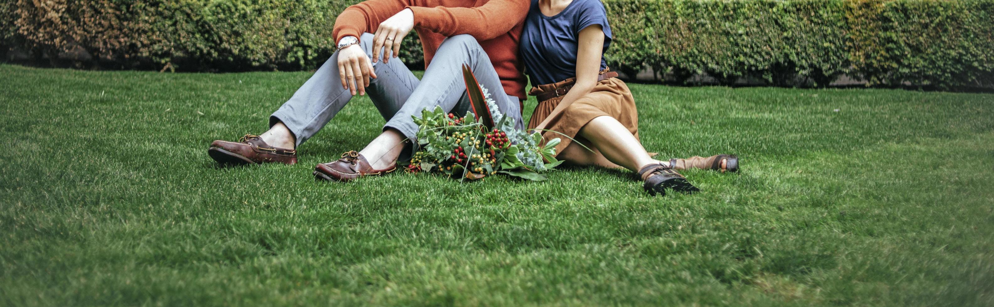 Couple on grass with flowers photo