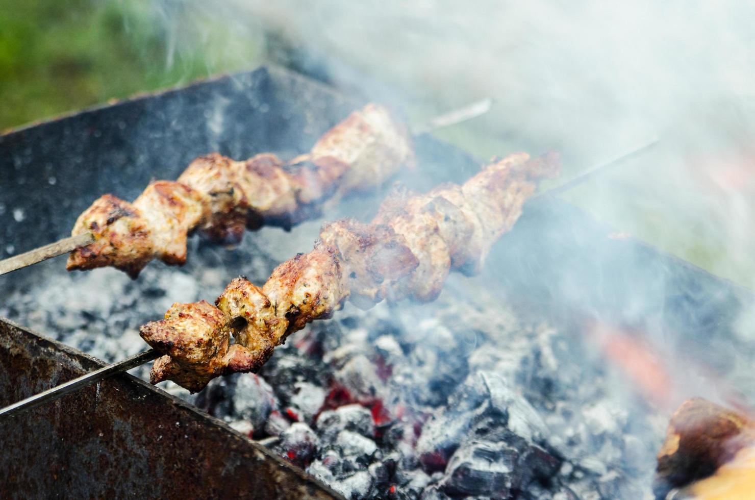 Meat on skewers being cooked photo